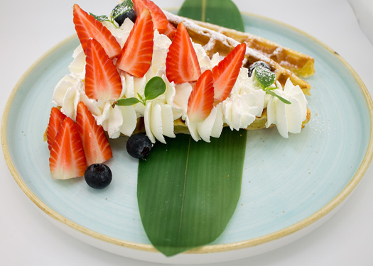 HOME-MADE WAFFLE WITH WHIPPING CREAN AND FRESH MIX BERRIES